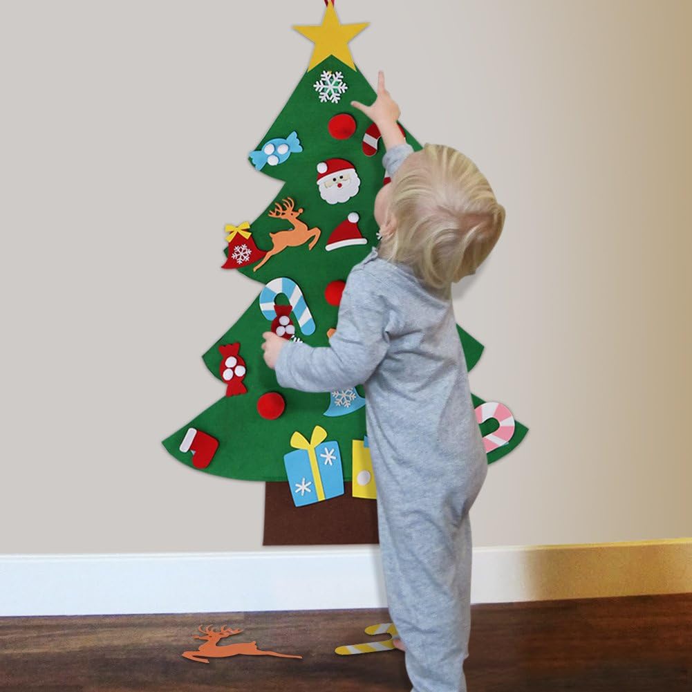 Toddler rearranging felt ornaments on tree