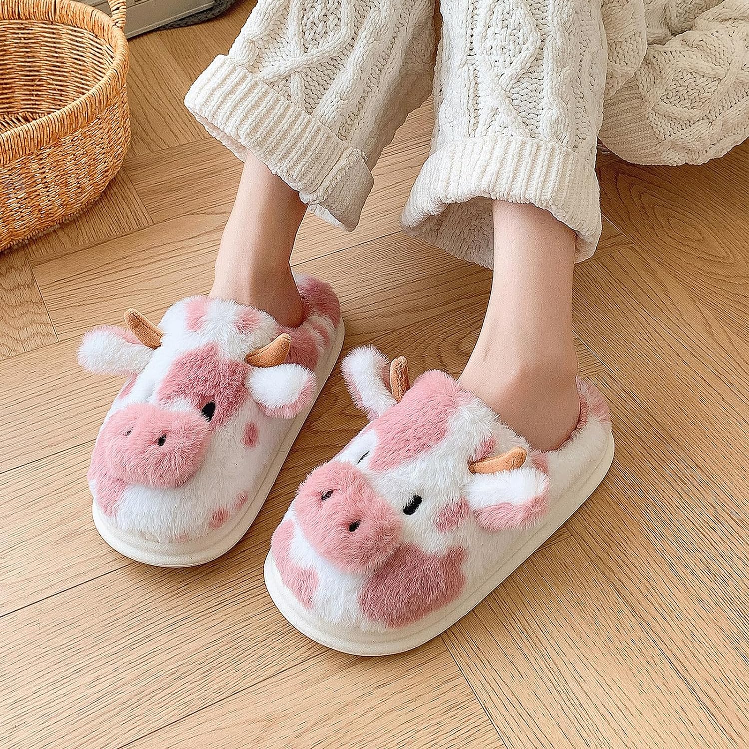 Fuzzy cow print house shoes pair
