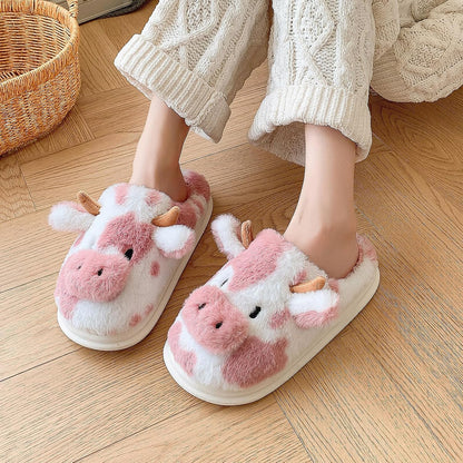 Fuzzy cow print house shoes pair